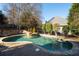 A kidney shaped pool with stone trim is accompanied by a tanning spa surrounded by lush landscaping at 1850 Kirkmont Nw Dr, Marietta, GA 30064