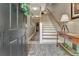 Inviting foyer with staircase, stylish rug, decor and light fixtures that leads into the home's interior at 1901 Sterling Oaks Cir, Atlanta, GA 30319