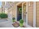 Close-up of a townhouse's front door with a wreath and decorative shrubbery at 1901 Sterling Oaks Cir, Atlanta, GA 30319