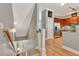 Open hallway featuring hardwood floors, gray walls, staircase with wooden handrail, leading to a stainless steel kitchen at 1901 Sterling Oaks Cir, Atlanta, GA 30319