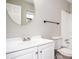 Bright bathroom featuring a modern vanity, round mirror, toilet, and shower with a white tub surround at 5474 Post Road Pass, Stone Mountain, GA 30088