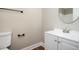 Neutral bathroom with dark fixtures, white vanity, and wood-look flooring at 5474 Post Road Pass, Stone Mountain, GA 30088