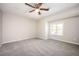 Well-lit bedroom with plush carpeting, neutral walls, and natural light at 5474 Post Road Pass, Stone Mountain, GA 30088