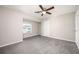 Spacious bedroom with carpet, neutral walls, ceiling fan, and a bright window at 5474 Post Road Pass, Stone Mountain, GA 30088