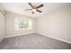 Bedroom with a ceiling fan, new carpeting, and a window to let in plenty of natural light at 5474 Post Road Pass, Stone Mountain, GA 30088