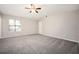 Bright bedroom with carpet, neutral walls, ceiling fan, and a bright window at 5474 Post Road Pass, Stone Mountain, GA 30088
