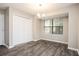 Inviting dining room features wood floors, ample natural light, and closet space at 5474 Post Road Pass, Stone Mountain, GA 30088