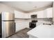 Modern kitchen featuring stainless steel appliances, quartz countertops, and white cabinets at 5474 Post Road Pass, Stone Mountain, GA 30088