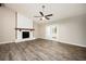 Bright living room with a ceiling fan, stone fireplace, and French doors leading to the outdoors at 5474 Post Road Pass, Stone Mountain, GA 30088