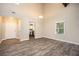 Open living room with stylish floors, a light fixture and a view into the kitchen at 5474 Post Road Pass, Stone Mountain, GA 30088