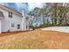 Spacious backyard with a white fence, tall trees, and well-maintained grass for outdoor enjoyment at 5705 Mountain Cres, Stone Mountain, GA 30087