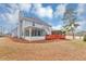 Rear of house featuring a sunroom and large deck, all set within a spacious backyard at 5705 Mountain Cres, Stone Mountain, GA 30087