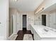 Bathroom featuring dark wood floors, a shower, and white double-sink vanity at 5705 Mountain Cres, Stone Mountain, GA 30087