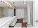 Bathroom featuring dark wood floors, a shower, tub, and a long white vanity at 5705 Mountain Cres, Stone Mountain, GA 30087