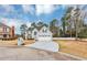 Beautiful home with well-maintained lawn, mature trees, and a long driveway leading to a two-car garage at 5705 Mountain Cres, Stone Mountain, GA 30087