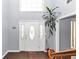 Bright foyer with hardwood floors, a decorative front door, and a plant adding a touch of nature at 5705 Mountain Cres, Stone Mountain, GA 30087