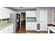 Another view of the kitchen showcasing white cabinets, hardwood flooring, and stainless steel refrigerator at 5705 Mountain Cres, Stone Mountain, GA 30087