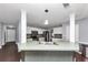 Well-lit kitchen with white cabinetry, a central island with a sink, and modern appliances at 5705 Mountain Cres, Stone Mountain, GA 30087