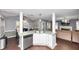 Open-concept kitchen with a breakfast bar seamlessly connects to the cozy living room area at 5705 Mountain Cres, Stone Mountain, GA 30087