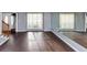 Bright living room boasting hardwood floors, abundant natural light, and a mirrored wall at 5705 Mountain Cres, Stone Mountain, GA 30087