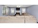 Cozy living room with a fireplace, large sectional sofa, and windows offering natural light at 5705 Mountain Cres, Stone Mountain, GA 30087