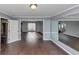 Living room showcasing hardwood flooring and a stainless steel refrigerator adjacent to an entryway at 5705 Mountain Cres, Stone Mountain, GA 30087