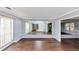 Spacious living room with hardwood floors and mirrored wall, enhancing the sense of space at 5705 Mountain Cres, Stone Mountain, GA 30087