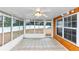 Bright sunroom with tiled floors, ceiling fan and large windows overlooking fenced backyard at 5705 Mountain Cres, Stone Mountain, GA 30087
