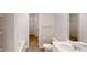 Bright bathroom with tub, toilet, white vanity, and walk in closet at 1010 Nandina Ct, Villa Rica, GA 30180