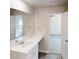 Bathroom vanity with sink, large mirror, and view into bedroom at 1010 Nandina Ct, Villa Rica, GA 30180