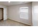 A bright bedroom with a window and blinds, neutral carpet and walls, and a closet at 1010 Nandina Ct, Villa Rica, GA 30180