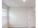 A bright bedroom with a window and blinds, neutral carpet and walls, and a doorway at 1010 Nandina Ct, Villa Rica, GA 30180