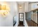 Welcoming hallway with stylish lighting fixtures, hardwood floors, and a view into the living area at 3715 Peachtree Ne Rd # 9, Atlanta, GA 30319