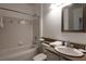 Clean bathroom featuring a vanity, tiled bath, and a framed mirror at 955 Juniper Ne St # 4229, Atlanta, GA 30309