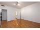 This bedroom features hardwood floors, a light fixture, and a view into the bathroom at 955 Juniper Ne St # 4229, Atlanta, GA 30309