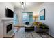 Bright living room with fireplace, sleek furnishings, and outdoor balcony access at 955 Juniper Ne St # 4229, Atlanta, GA 30309