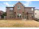 Exterior back of the house with brick, windows and yard at 2100 Trinity Mill Dr, Dacula, GA 30019