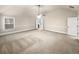 Bedroom featuring neutral carpet, ceiling fan, and ensuite bath access at 2100 Trinity Mill Dr, Dacula, GA 30019
