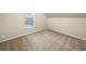 Bedroom features carpeted flooring, a window for natural light, and neutral walls at 2100 Trinity Mill Dr, Dacula, GA 30019