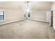 Large bedroom with neutral carpet, a ceiling fan, and two windows providing natural light at 2100 Trinity Mill Dr, Dacula, GA 30019