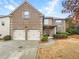 Charming brick home with a two-car garage and well-maintained landscaping at 2100 Trinity Mill Dr, Dacula, GA 30019