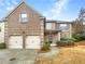 Traditional brick home with two-car garage and manicured front yard at 2100 Trinity Mill Dr, Dacula, GA 30019