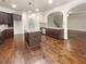 Spacious kitchen features wood floors, dark cabinets, granite counters and a center island with seating at 2100 Trinity Mill Dr, Dacula, GA 30019