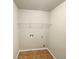 Laundry room features tile flooring, shelving, and hookups for a washer and dryer at 2100 Trinity Mill Dr, Dacula, GA 30019