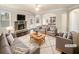 Cozy living room with a stone fireplace and open access to the kitchen at 2100 Trinity Mill Dr, Dacula, GA 30019