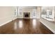 Open-concept living room features wood floors, a fireplace, and plenty of natural light at 2100 Trinity Mill Dr, Dacula, GA 30019