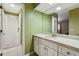 Bathroom featuring a walk-in shower, white cabinets, and a large mirror at 3454 Ashwood Ln, Atlanta, GA 30341