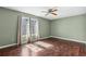 Bedroom featuring dark wood floors, ceiling fan, and large window at 3454 Ashwood Ln, Atlanta, GA 30341
