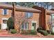 Brick townhouse featuring a bay window, shutters, and landscaped front yard at 3454 Ashwood Ln, Atlanta, GA 30341