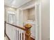 Hallway landing with laundry closet, white doors, and wood floors at 3454 Ashwood Ln, Atlanta, GA 30341